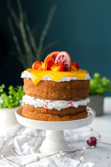 Layer cake with citrus curd on a white stand